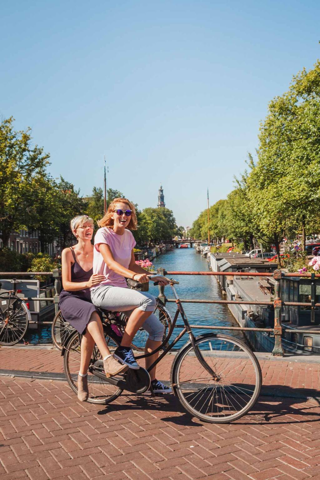 Lesbian couple on a bicycle in Amsterdam, Netherlands