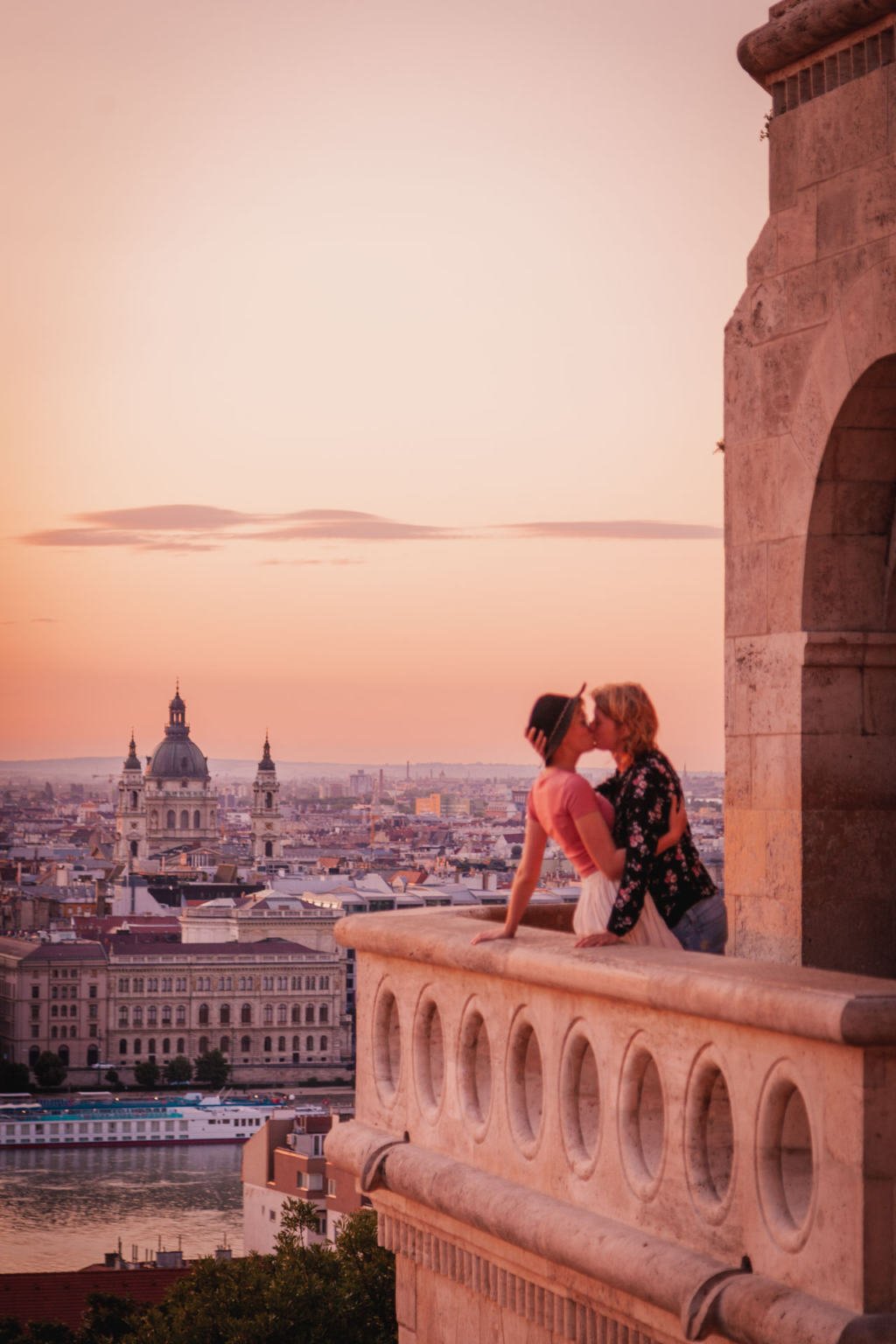 Gay couple kissing at the Fisherman's Bastion in Budapest during sunrise, Hungary