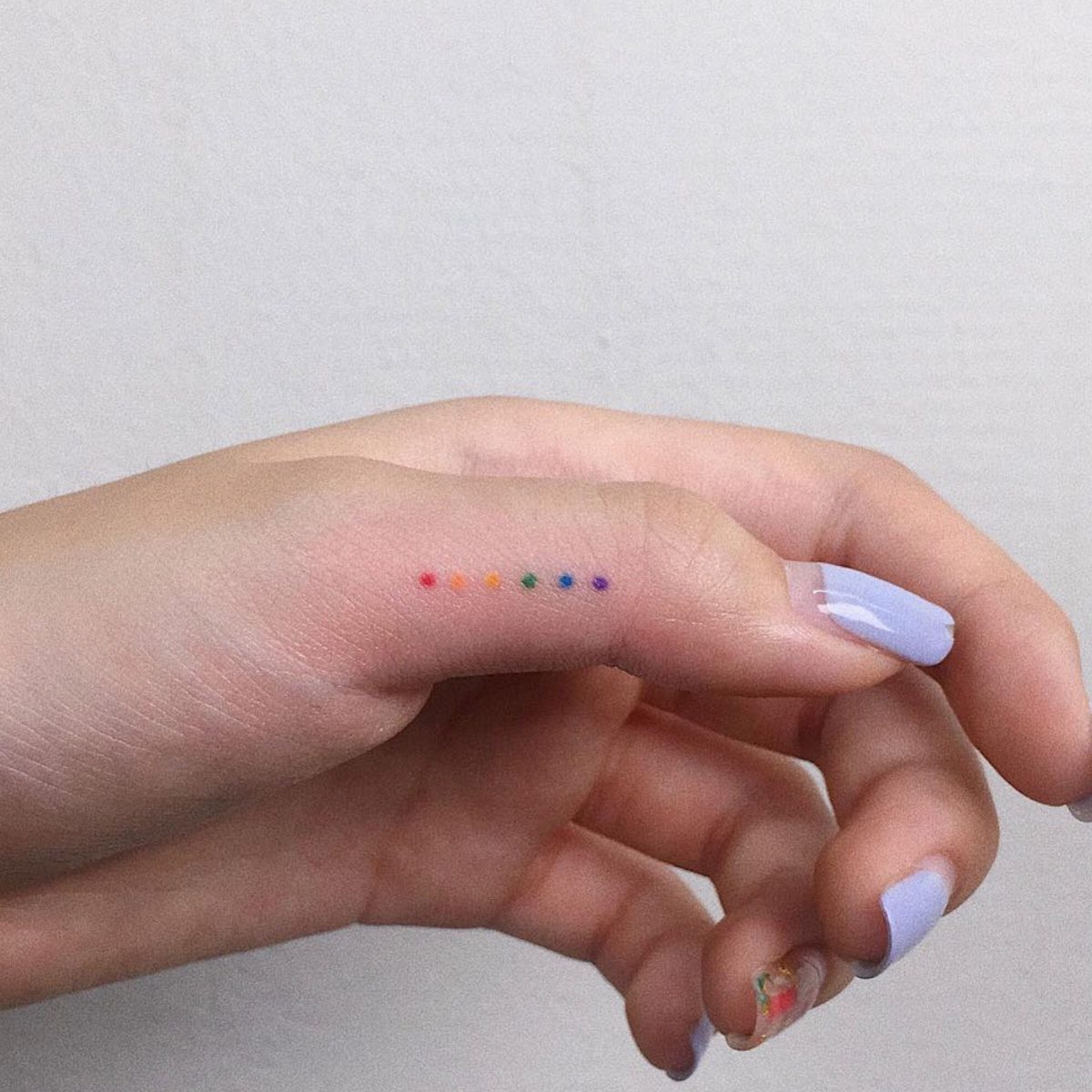 Rainbow dots on finger by @the_gloomy___
