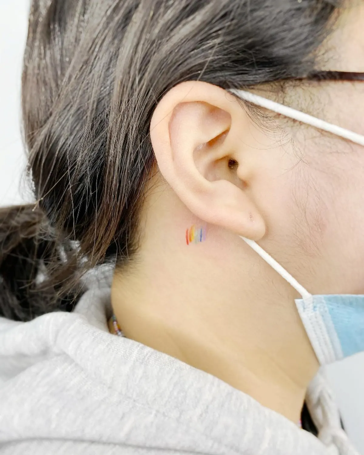 Small rainbow tattoo neck tattooist_yunseul